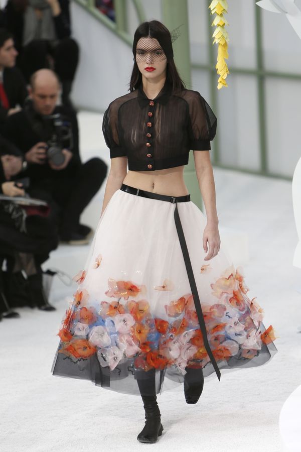 Kendall Jenner walks on runway wearing midriff-baring sheer blouse during the Chanel show as part of Paris Fashion Week Haute Couture Spring/Summer 2015